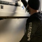 Hamilton Electrical Contractor Service technician checking panel breakers